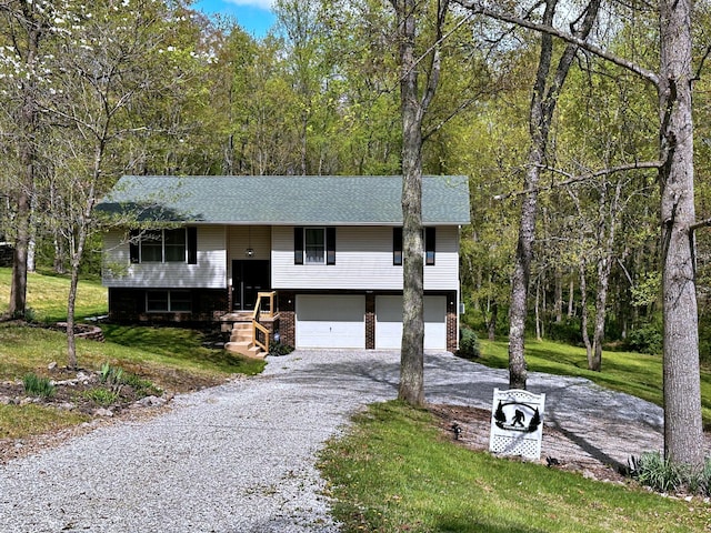 split foyer home featuring a garage and a front lawn