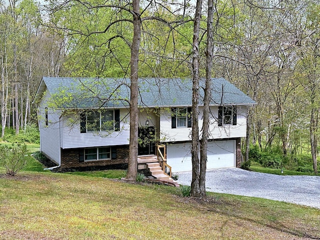 split foyer home with a front yard and a garage