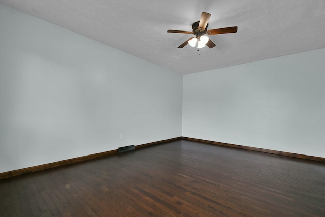 spare room with a textured ceiling, ceiling fan, and dark hardwood / wood-style floors