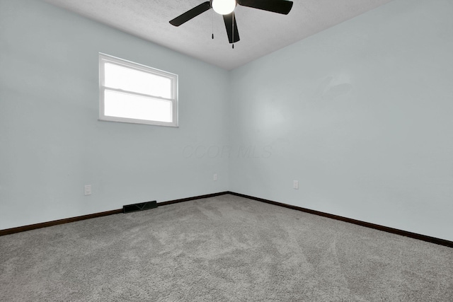 unfurnished room featuring carpet flooring, a textured ceiling, and ceiling fan