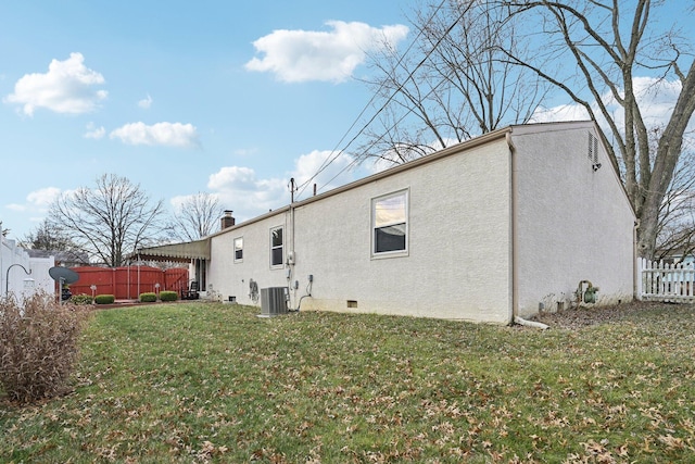 back of property featuring a yard and central air condition unit