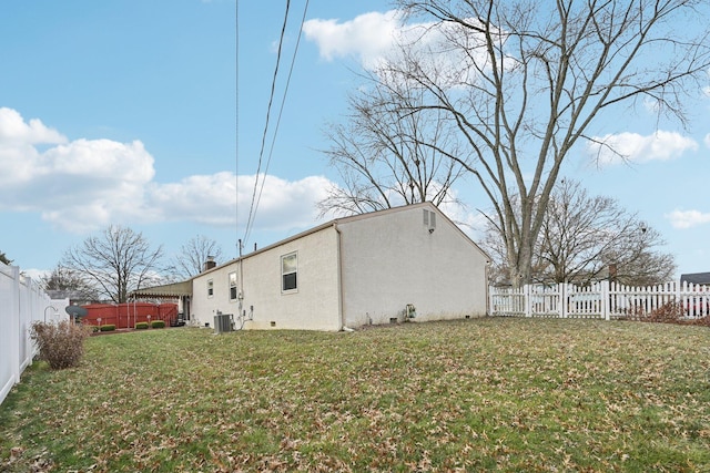 view of side of home featuring a yard and cooling unit