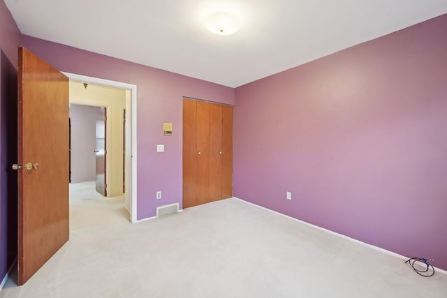 carpeted bedroom featuring a closet