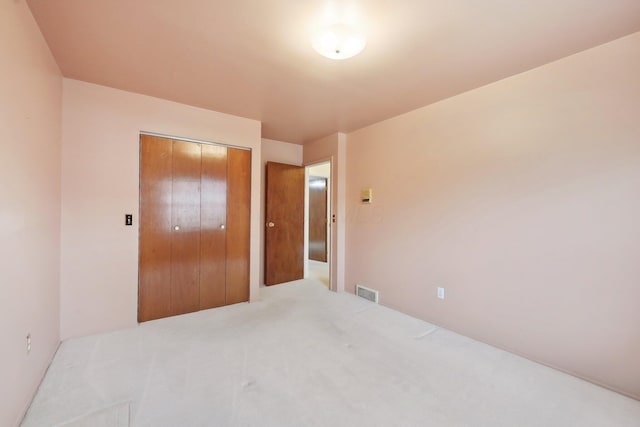 carpeted bedroom featuring a closet