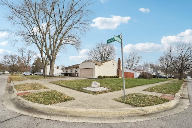 exterior space featuring a lawn and a garage