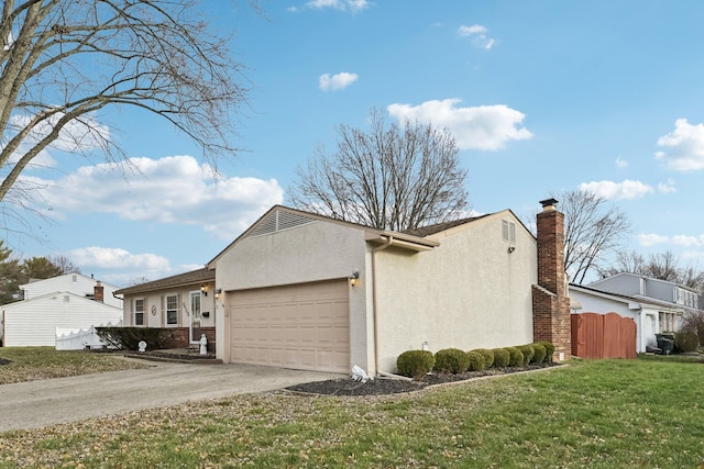 view of side of property featuring a yard and a garage