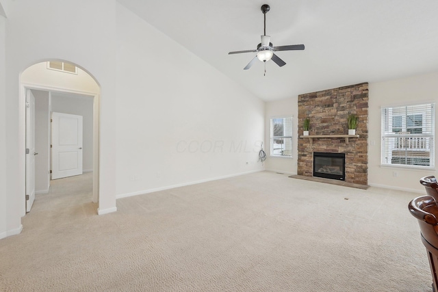 unfurnished living room featuring high vaulted ceiling, light carpet, a fireplace, and ceiling fan