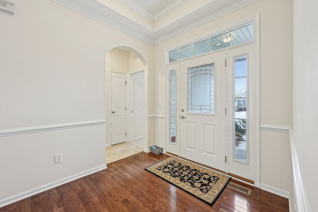 entrance foyer featuring ornamental molding and hardwood / wood-style floors