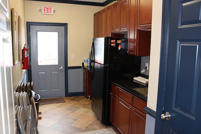 kitchen featuring black refrigerator and ornamental molding