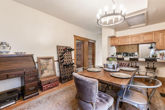 dining room with a chandelier and light wood-type flooring