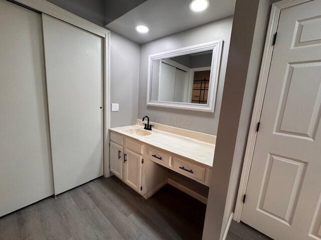 bathroom with wood-type flooring and vanity