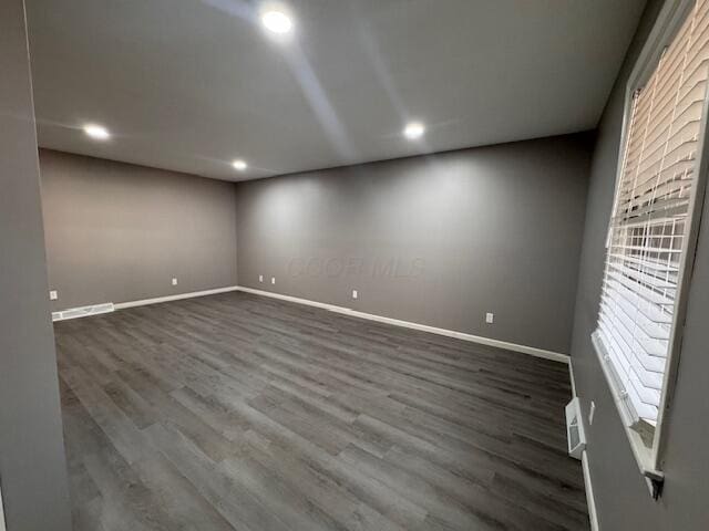 empty room with dark wood-type flooring