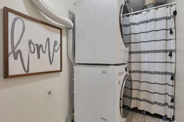 interior space featuring hardwood / wood-style floors and stacked washing maching and dryer