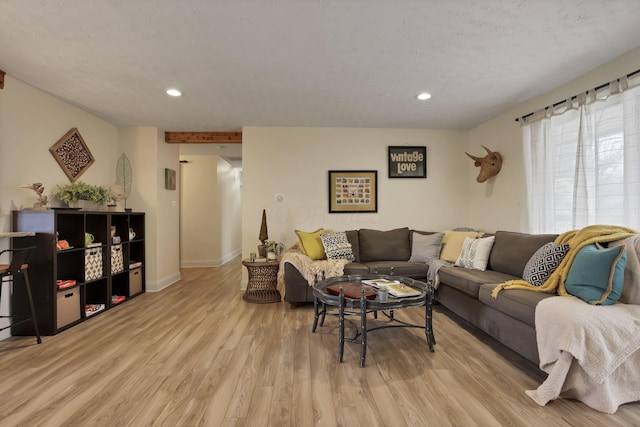 living room featuring a textured ceiling and light wood-type flooring