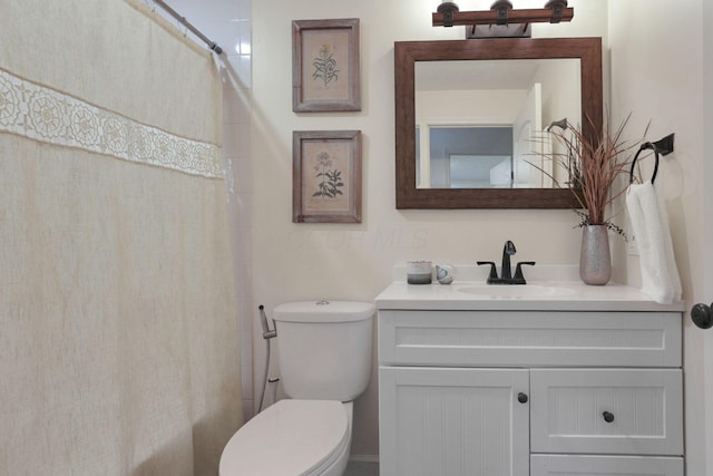 bathroom with vanity, toilet, and walk in shower