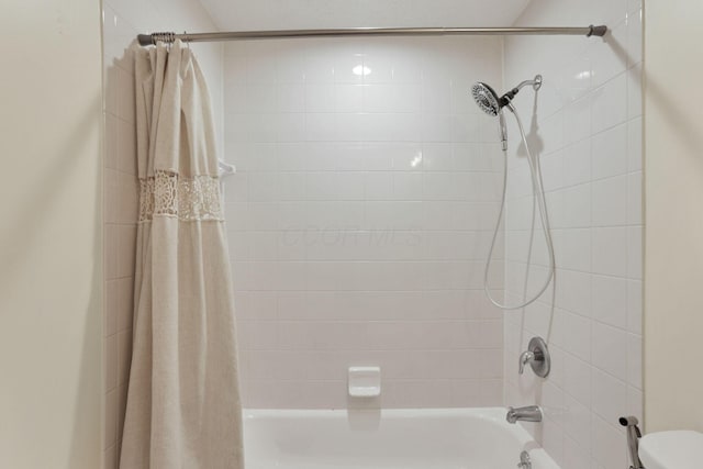 bathroom with shower / bath combo with shower curtain