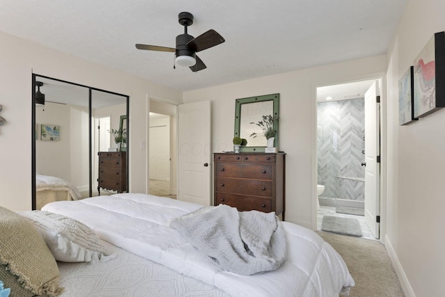 carpeted bedroom featuring connected bathroom, a closet, and ceiling fan