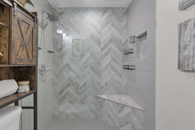 bathroom with toilet and tiled shower