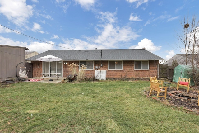 rear view of property with a lawn and a patio area