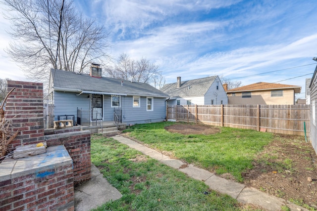 rear view of house with a yard