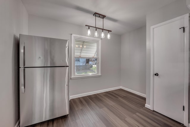 unfurnished dining area with dark hardwood / wood-style floors