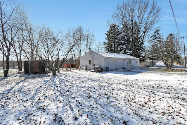 view of snow covered rear of property