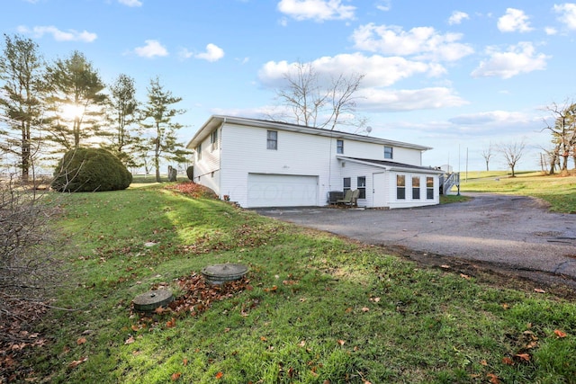 exterior space with a lawn and a garage