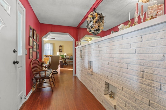 hall with dark hardwood / wood-style floors and a textured ceiling