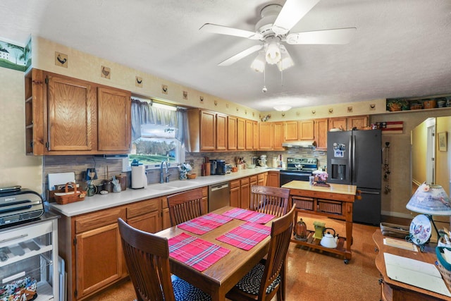 kitchen with backsplash, ceiling fan, sink, and appliances with stainless steel finishes