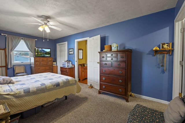 bedroom featuring ceiling fan, a closet, light carpet, and a textured ceiling