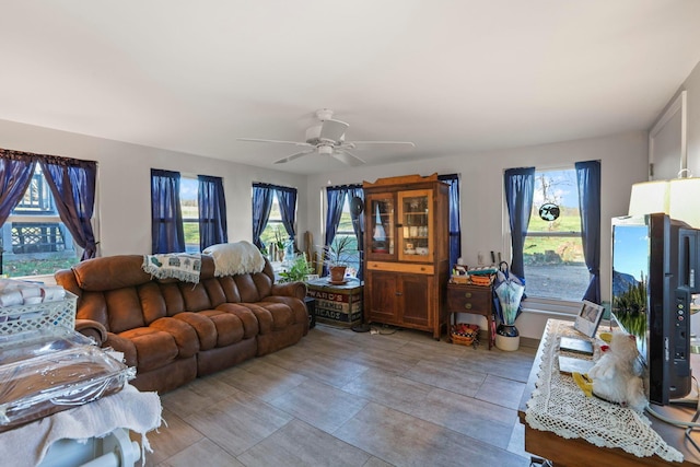 living room with ceiling fan and plenty of natural light