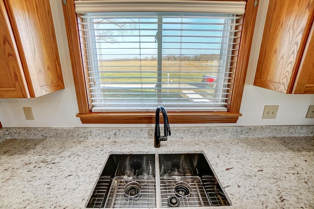 details featuring light stone counters and sink