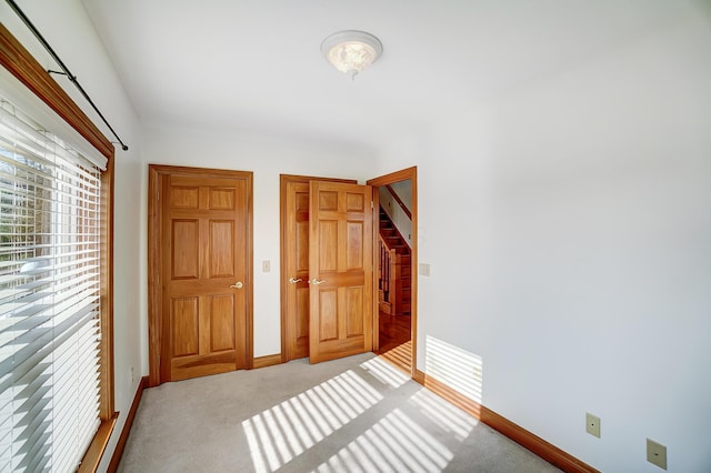 unfurnished bedroom featuring light colored carpet