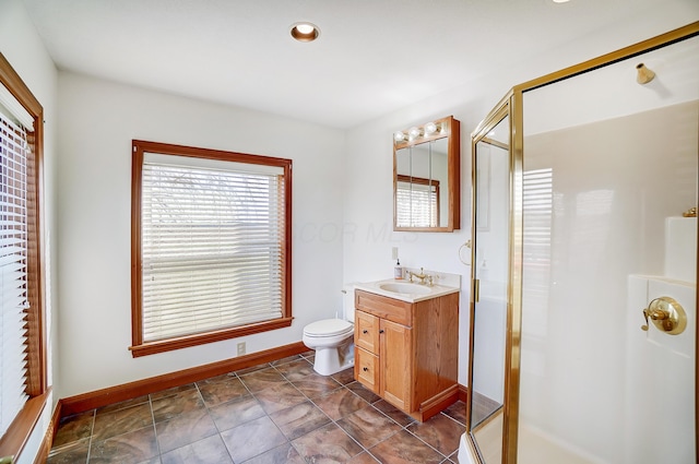 bathroom featuring vanity, an enclosed shower, and toilet