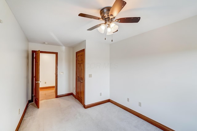 unfurnished bedroom with ceiling fan and light colored carpet