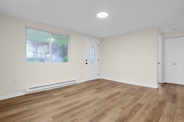 entrance foyer with light wood-type flooring and a baseboard heating unit