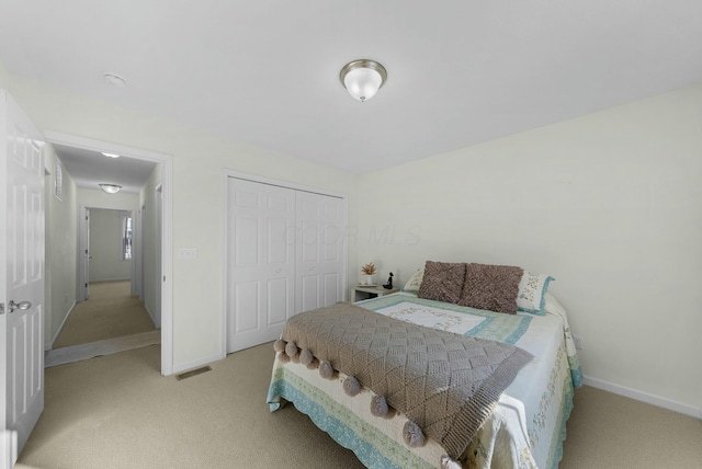 carpeted bedroom with a closet