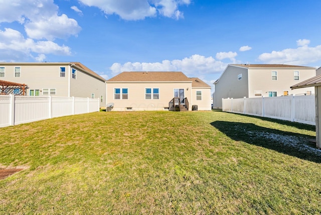 rear view of property featuring a lawn