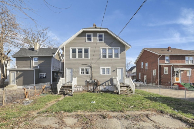 rear view of property featuring a yard