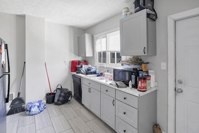 kitchen with sink, black appliances, and a textured ceiling