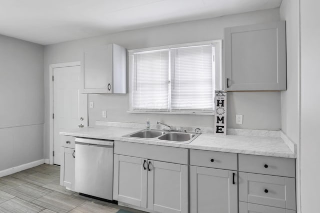 kitchen featuring dishwasher, light hardwood / wood-style floors, and sink