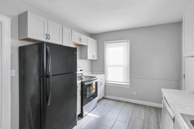 kitchen with sink, white cabinets, and appliances with stainless steel finishes