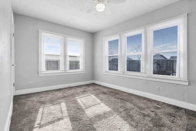 carpeted empty room featuring a textured ceiling and ceiling fan