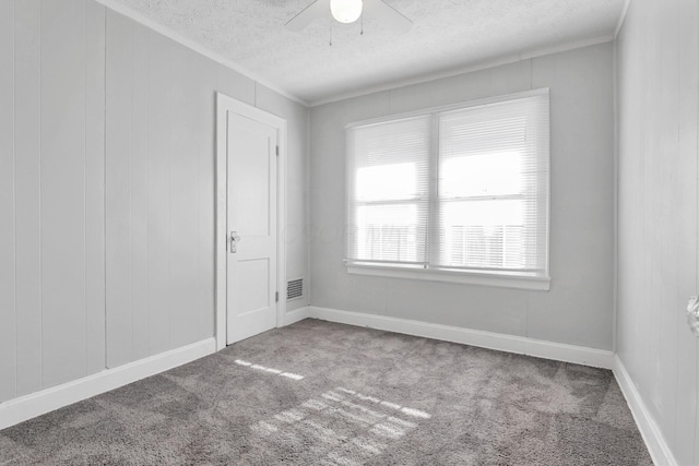 unfurnished room featuring ceiling fan, carpet, and a textured ceiling