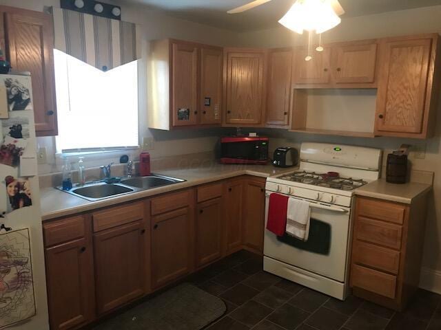 kitchen featuring ceiling fan, white appliances, and sink