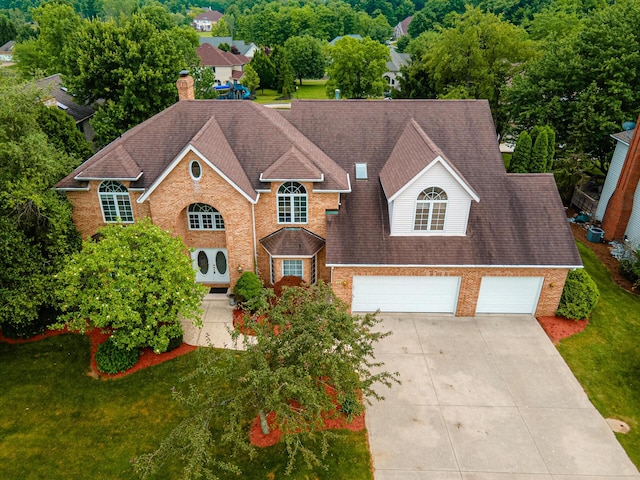 view of front of home with a garage and a front lawn