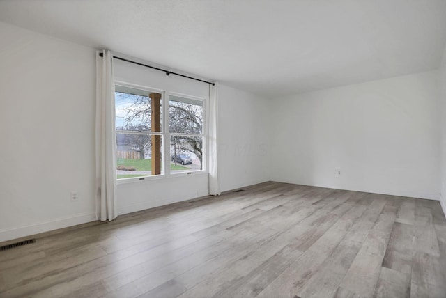 spare room with light wood-type flooring