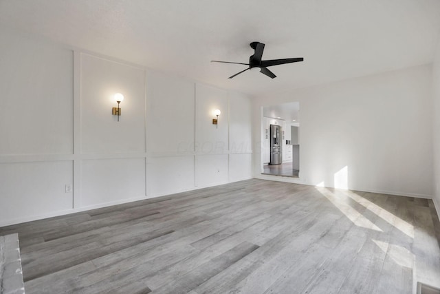 empty room featuring hardwood / wood-style floors and ceiling fan