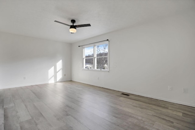 spare room featuring ceiling fan and light wood-type flooring