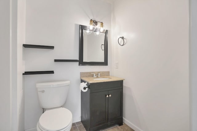 bathroom with tile patterned floors, vanity, and toilet